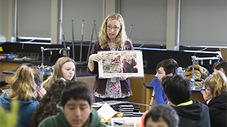 Image of Laura Six teaching a class about forest ecology.