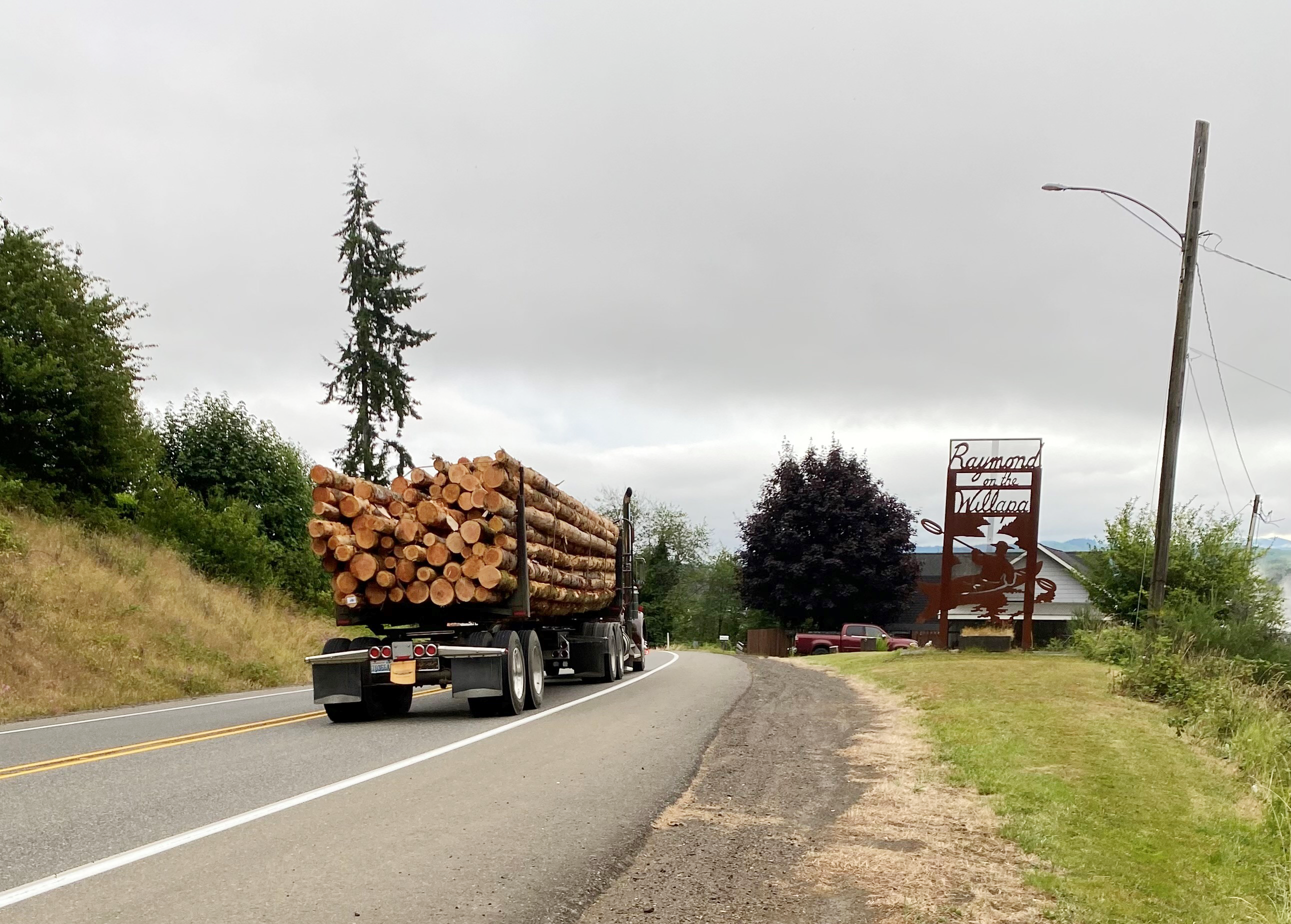 Image of a log truck heading to the Raymond mill.