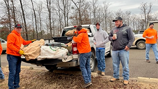 Image of members of the Arkansas-Oklahoma Timberlands Team prepping for a day of planting trees for Idabel neighbors.