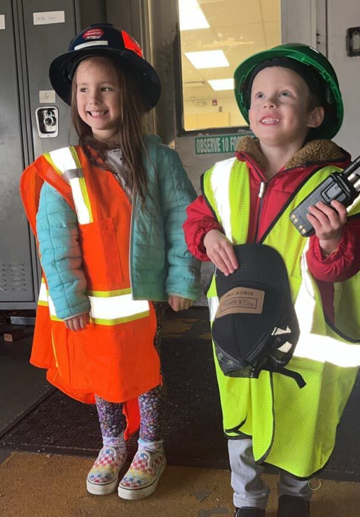 Image of two of Peter's children, Quinn and Desmond, wearing PPE while visiting Peter at work at our Tacoma DC.