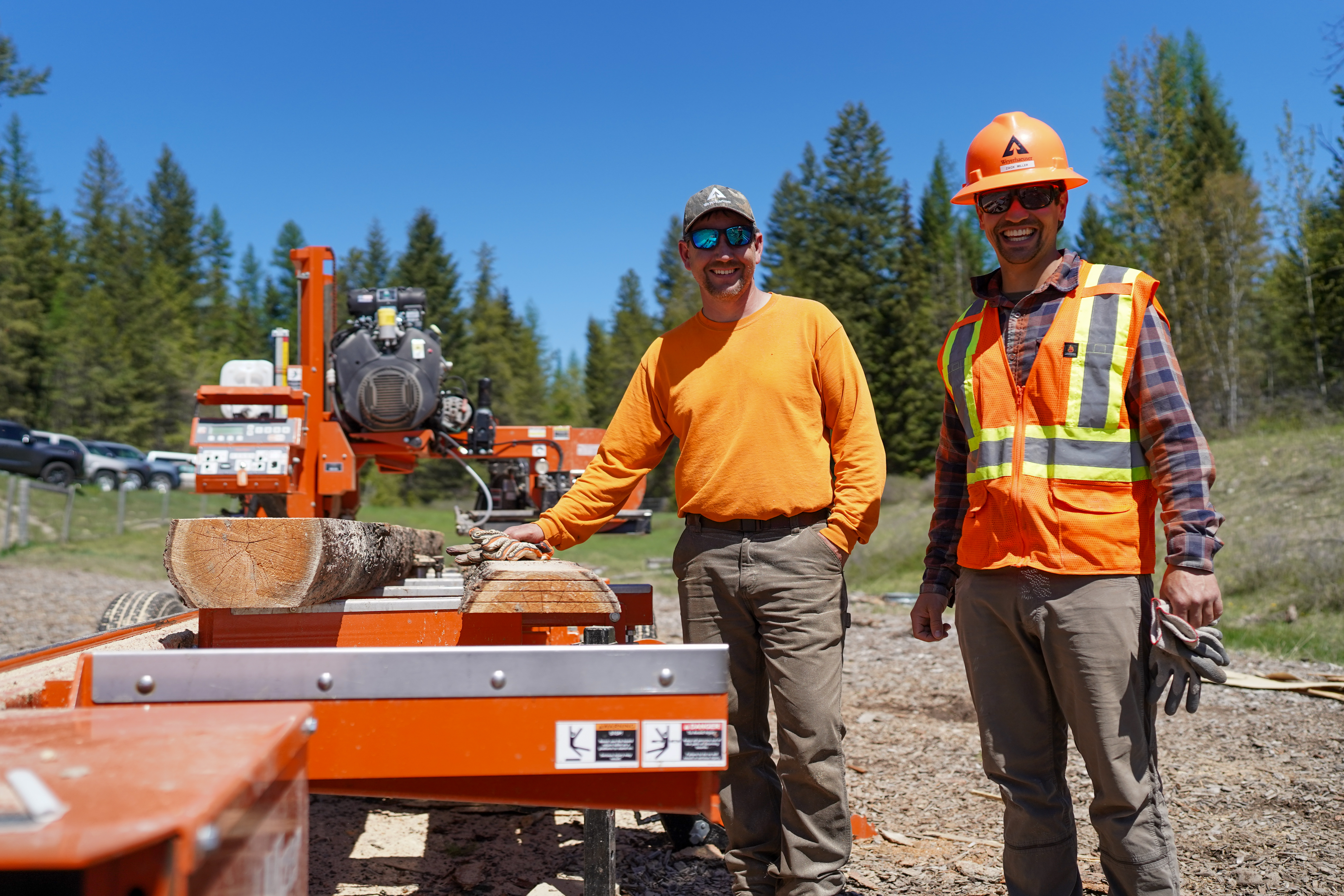 Image of Jeremy Wilke and Zack showing off a portable sawmill at Montana's Family Forestry Expo.