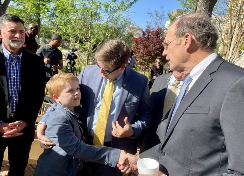 Image of Alex introducing his son to Mississippi Lt. Gov. Hosemann following the passage of the state's Outdoor Stewardship Trust Fund in 2022.