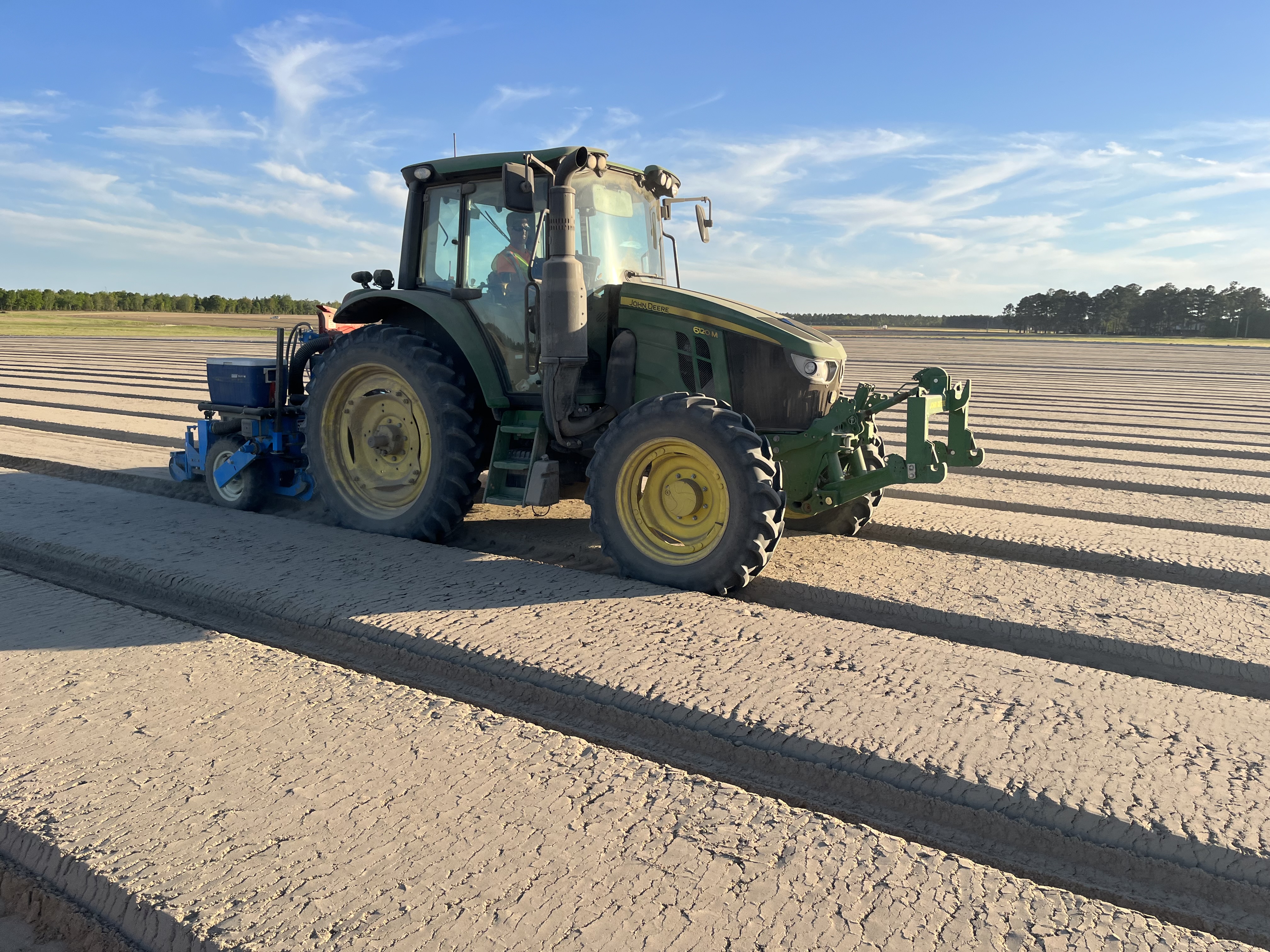 Image of Cory operating a vacuum sower.