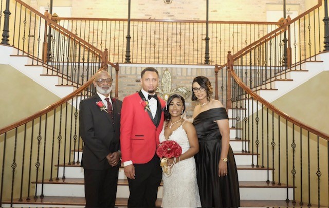Image of Evelle with Carlos, her son Ronald and daughter-in-law Jada at Ronald and Jada's wedding.