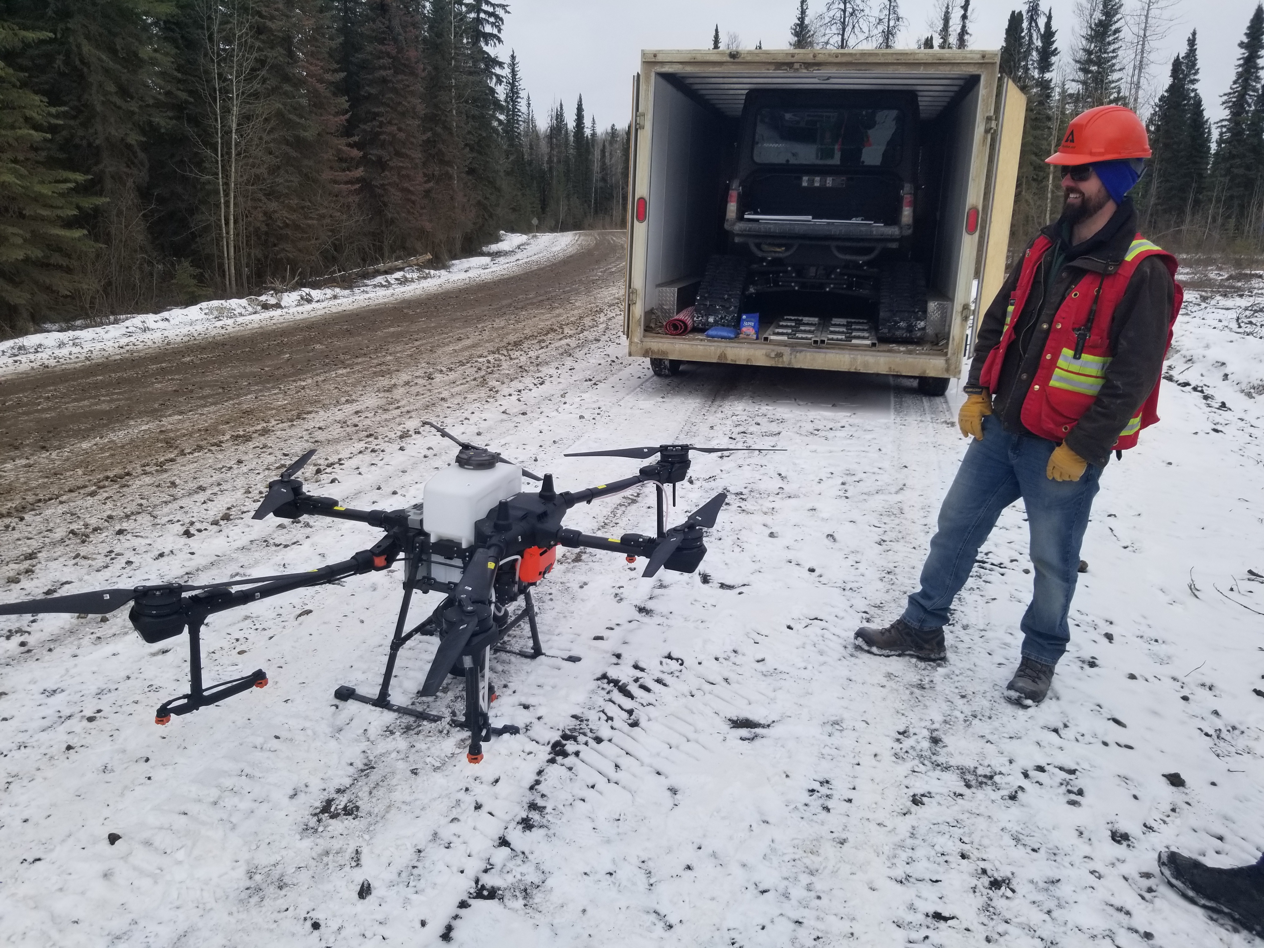 Image of Tyler Niles setting up a drone to give a demonstration of Grande Prairie's drone seeding program.