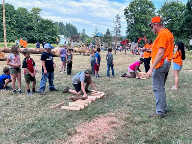 Image of some of the participants in the youth logging competitions, which include forewood stacking.