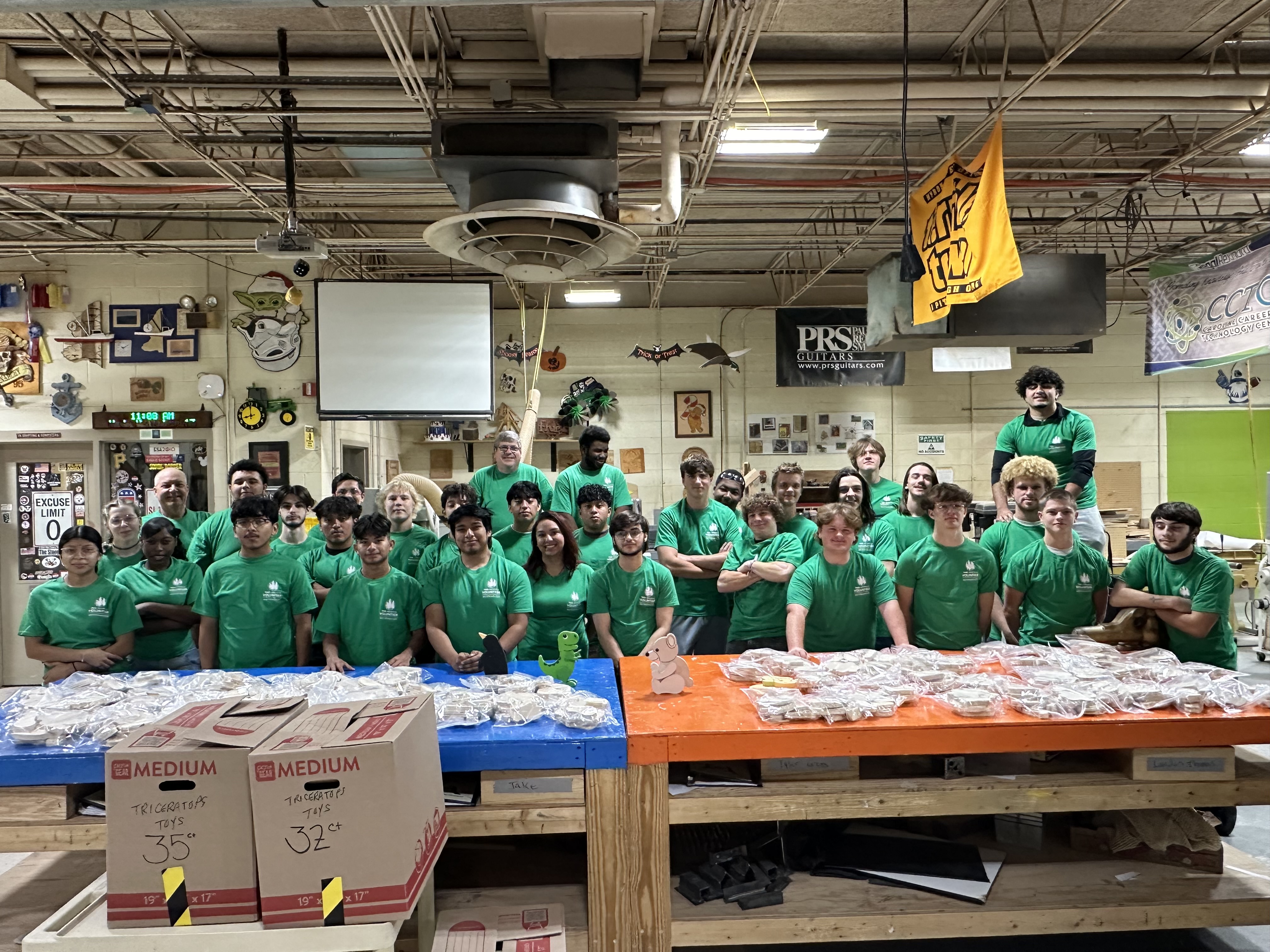 Image of CCTC students who helped create the wooden toys, all in Weyerhaeuser t-shirts.