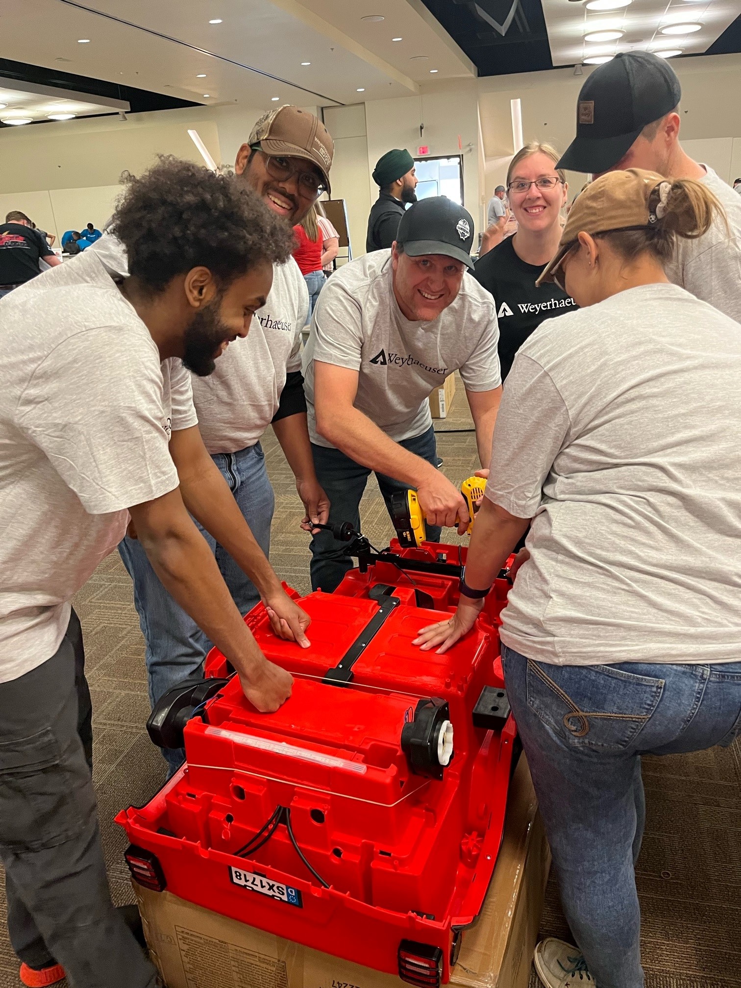 Image of volunteers working together to assemble the car for Noah.