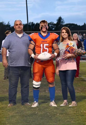 Kevin and Reagan pictured with their son Kalor during his senior night playing high school football at North Pontotoc.